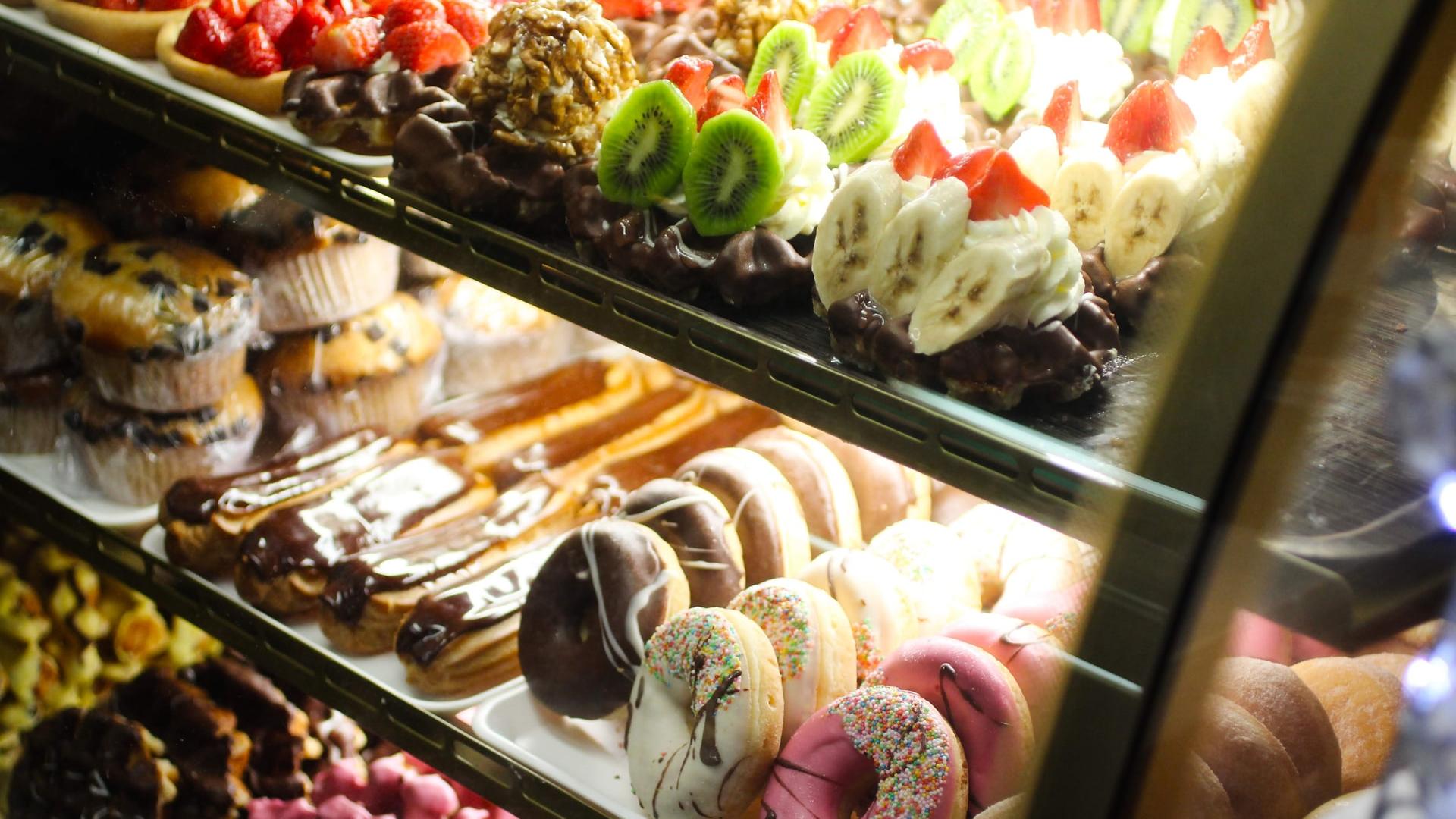 assorted cupcakes on glass display counter